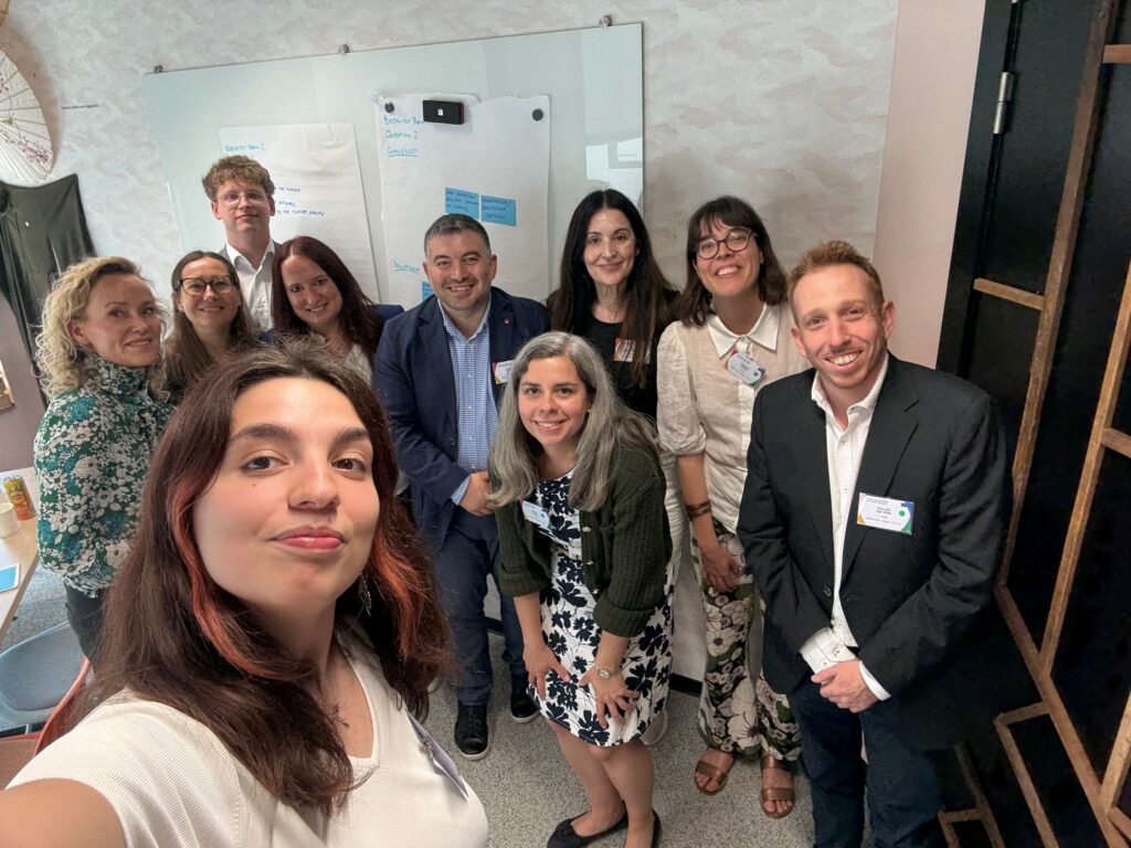 a group of people taking a selfie in a conference room